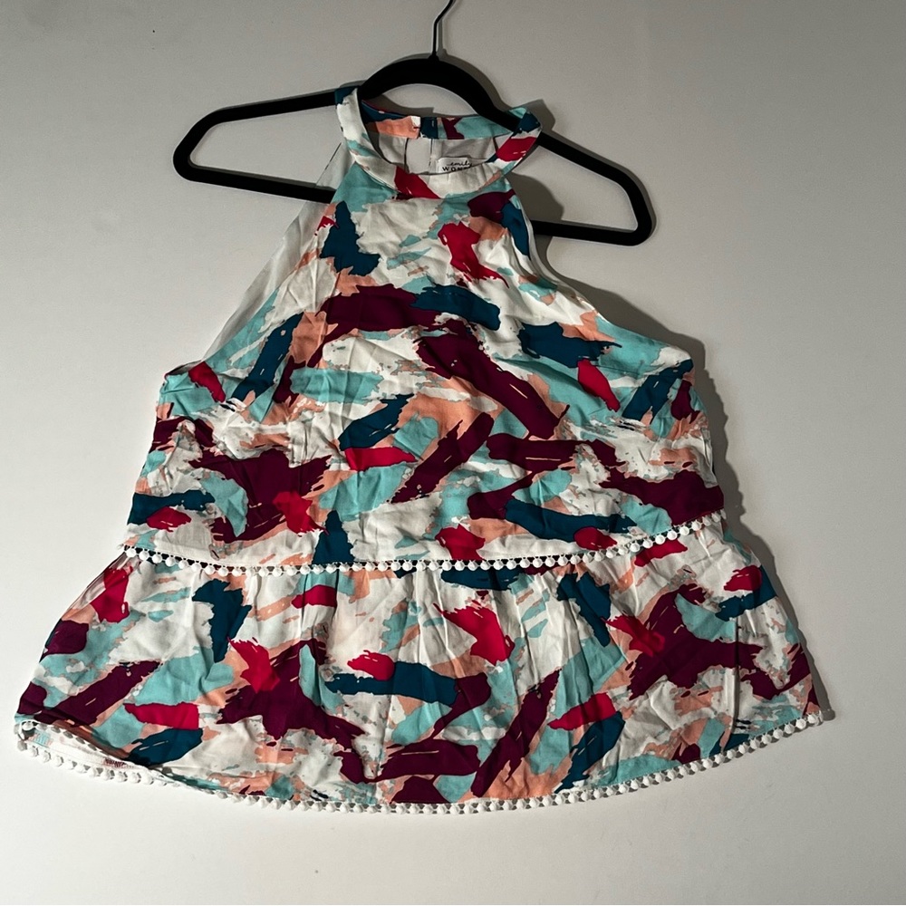 Halter neck, abstract, floral tank with ruffled hemline.